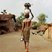 Image 7: A woman carrying pots on her head