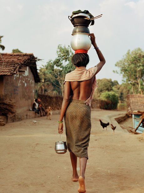 A woman carrying pots on her head