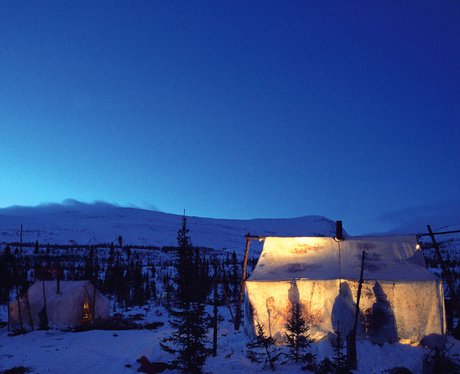 A hut set against a snowy backdrop