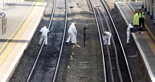 Police search the tracks at Slough