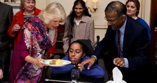 Duchess of Cornwall serving sausage and mash