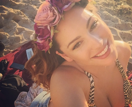 Kelly Brook wears flowers on the beach