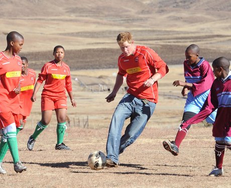 Prince Harry playing football with orphaned children during his visit to Africa