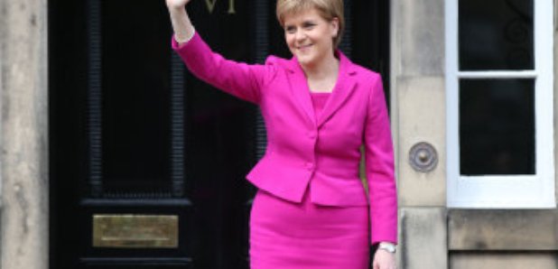 Nicola Sturgeon waves from the steps of Bute House