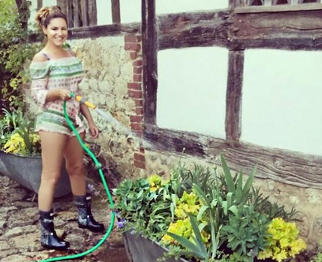 Kelly Brook gardening in summer in a playsuit