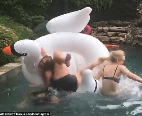 Dakota Fanning falls off an inflatable swan
