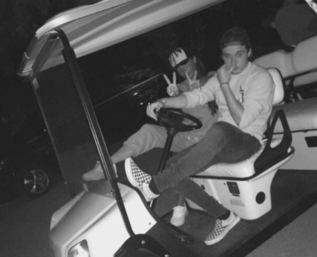 Victoria Beckham and Brooklyn Beckham in a golf bu